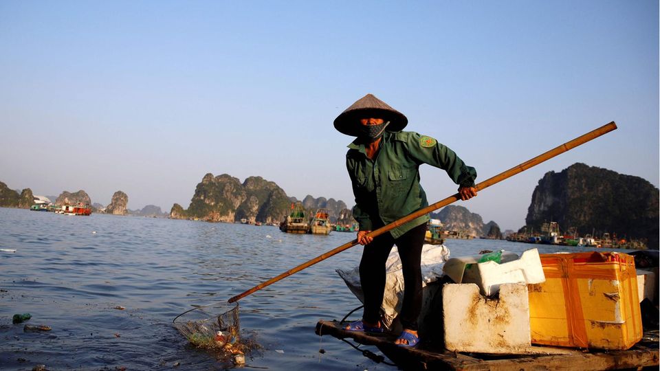 Worker collecting rubbish from Halong Bay in northeastern Vietnam