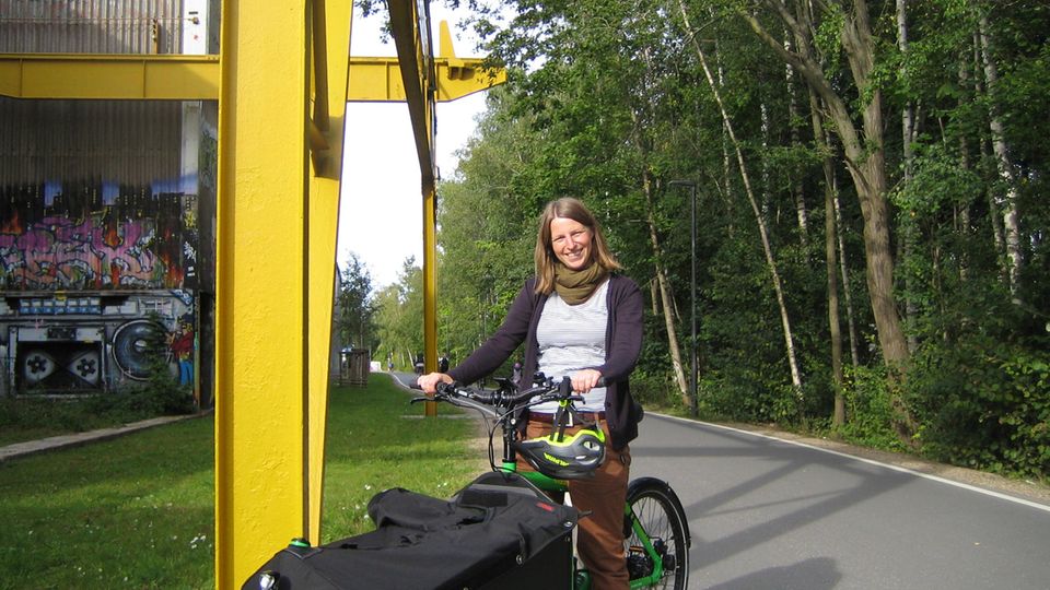 Young woman on green cargo bike