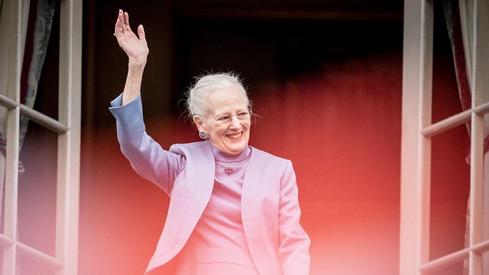 Queen Margrethe II of Denmark waves from the balcony