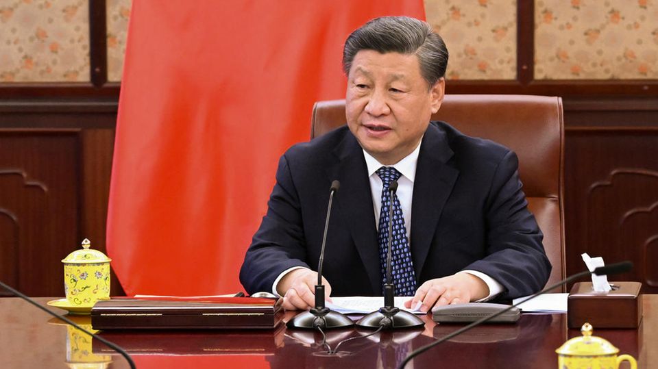 Xi Jinping, President of the People's Republic of China, sits at a table