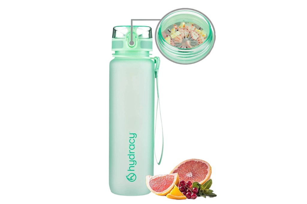 Light green Hydracy drinking bottle on white background with detail bubble to insert with diced fruit and grapefruit cut in half next to it