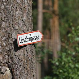 Symbolic picture: An arrow sign with the inscription "extinguishing water" is nailed to a tree. (Source: imago images/A.Gora)