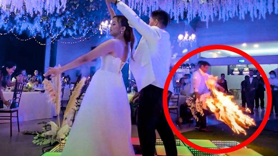 The bridal couple dances romantically – but the star of the wedding video is the fire in the background