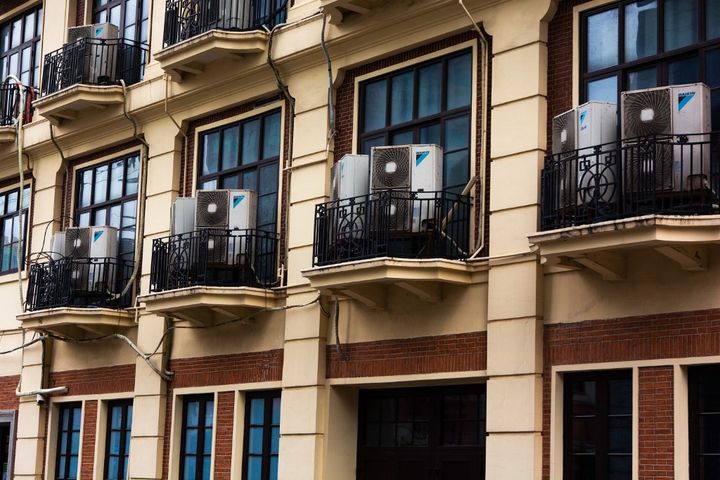 Air conditioners installed in apartments in Shanghai, China, on July 13, 2023. (YING TANG / NURPHOTO / AFP)