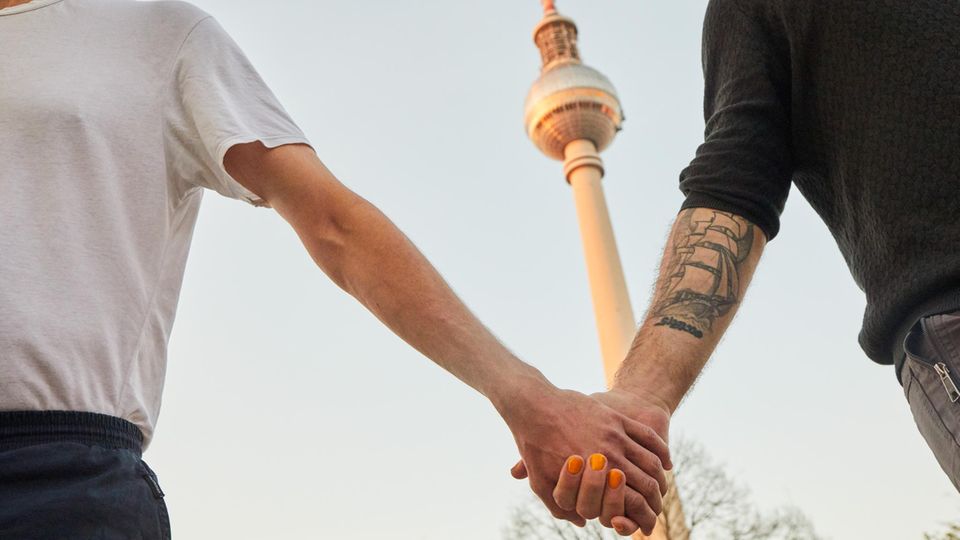 Stephan Seiler and Simon holding hands on Alexanderplatz