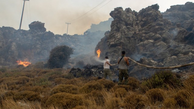 Greece: Locals try to bring the fire under control at Lindos.