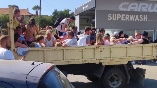 Greece: Tourists on Rhodes are brought to safety on all kinds of vehicles.