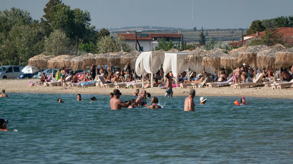 Bathers on a beach on Greece's Halkidiki peninsula