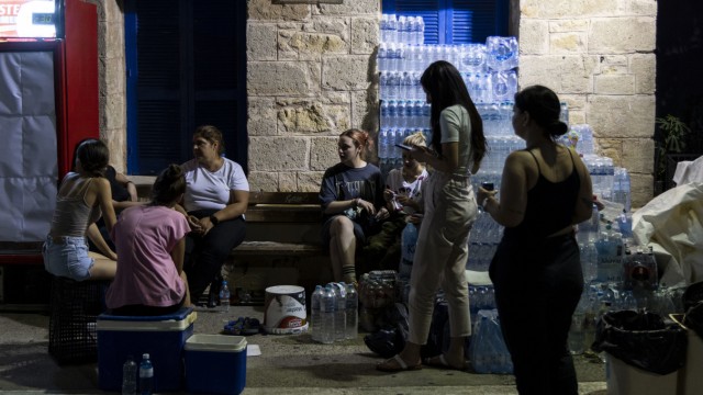 Southern Europe: Women have organized a food and drink collection point to feed the helpers fighting the forest fires.