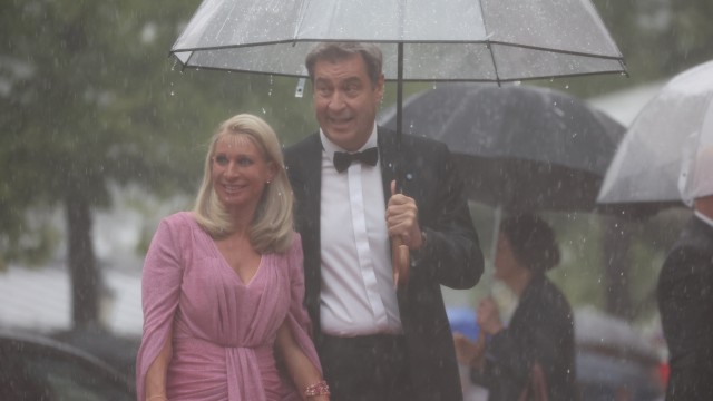 Richard-Wagner-Festspiele: Stieg wegen des starken Regens minutenlang nicht aus der Limousine aus: Bayerns Ministerpräsident Markus Söder mit seiner Ehefrau Karin.