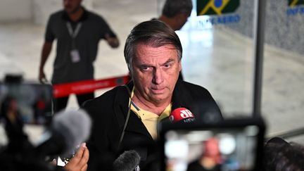 Former Brazilian President Jair Bolsonaro speaks to the media upon his arrival at the airport in Rio de Janeiro, Brazil, on June 29, 2023. (MAURO PIMENTEL / AFP)