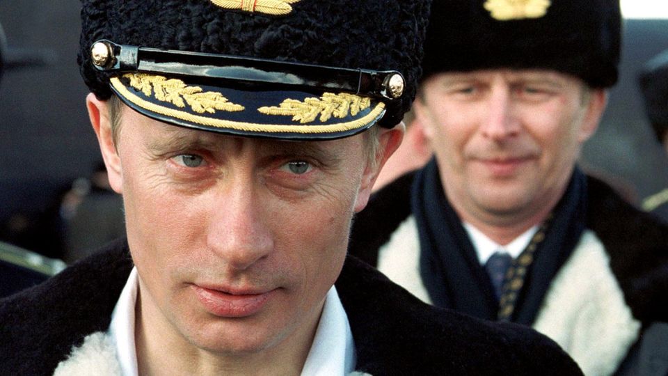 Vladimir Putin wears a naval officer's uniform