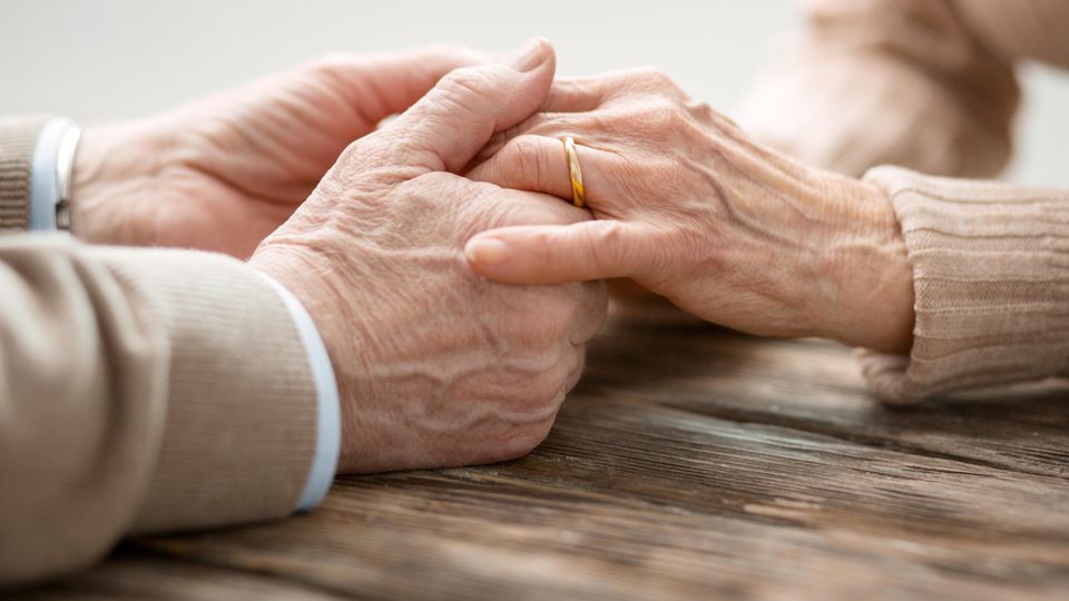Elderly people's hands with wedding rings
