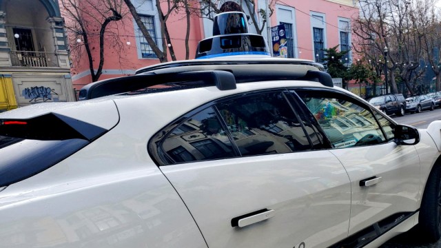 Autonomous driving: A Waymo robotaxi in San Francisco with the typical roof structure full of sensors.