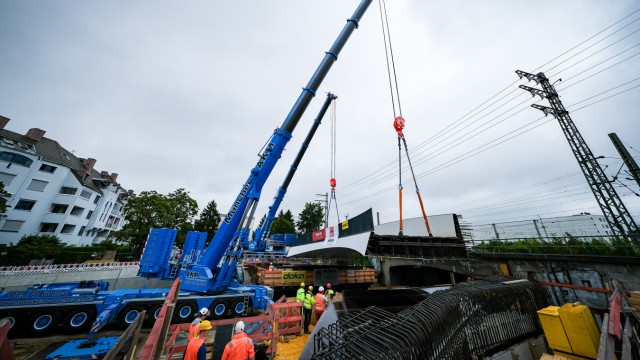 Pasing: The new pedestrian and cycle path bridge over Offenbachstrasse north of the railway line in Pasing is being lifted in place using heavy equipment.