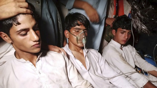 Pakistan: The youths, who had to wait for hours in a gondola, receive help from villagers after being rescued.