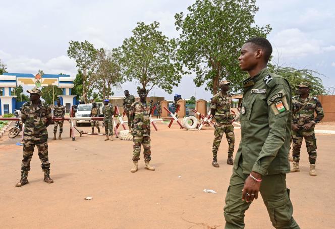 Nigerien soldiers stand guard as supporters of the National Council for the Safeguarding of the Homeland (CNSP) gather for a demonstration in Niamey, the capital, on August 11, 2023.