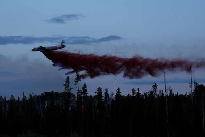 A plane responds to a fire near the town of Vanderhoof, British Columbia, province of Western Canada.  July 17, 2023.