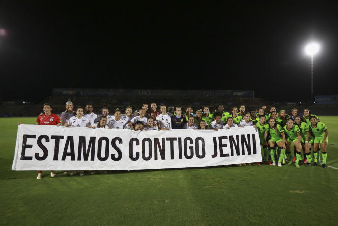 Players of the women's team from the Mexican city of Pachuca pose with a poster that reads 
