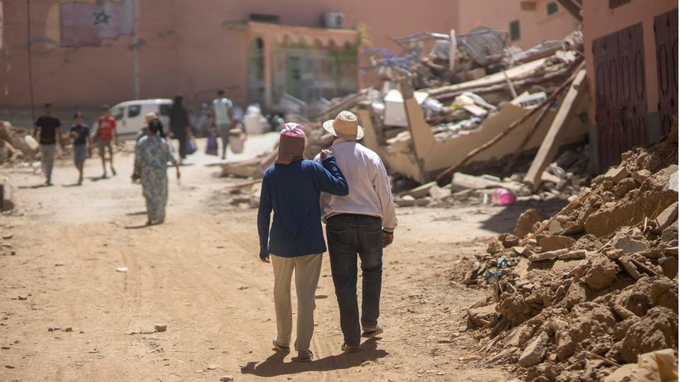 Morocco: People walk through the rubble of the earthquake in the town of Amizmiz near Marrakesh