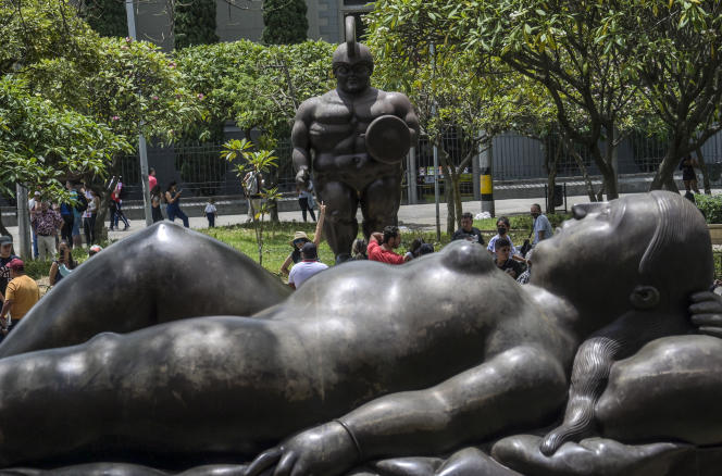 In front of a sculpture by Fernando Botero in Plaza Botero, in Medellin (Colombia), April 15, 2022.