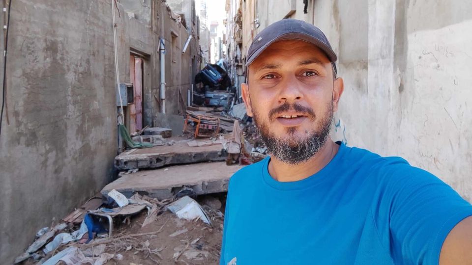 Mohamed Mneina in a devastated alley in Derna