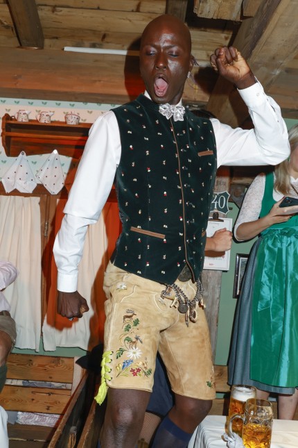 Celebrities at the Oktoberfest: Model Papis Loveday dances in the beetle tent.