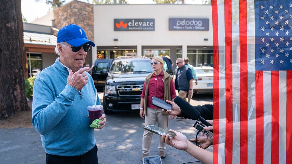 Joe Biden with a baseball cap and a smoothie in his hand