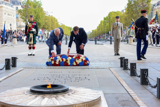 King Charles III and Emmanuel Macron lay a wreath in front of the flame of the tomb of the Unknown Soldier, under the Arc de Triomphe, in Paris, September 20, 2023.