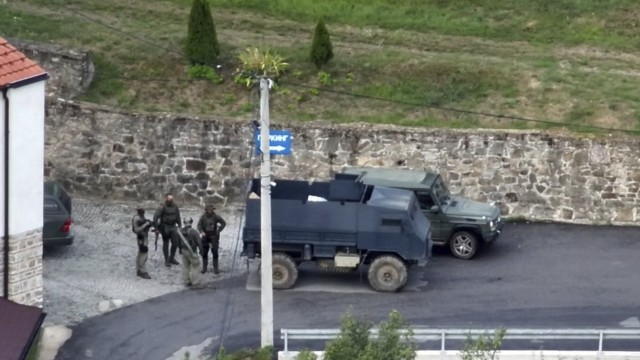 Balkans: This image released by police purports to show a group of armed, masked men in front of the Banjska monastery they are occupying.