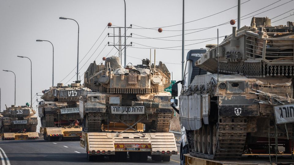Israel Defense Forces tanks are transported by trucks