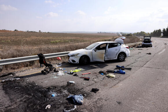 Personal belongings, including a child's pram, are seen on the road next to a car, near Kibbutz Kfar Aza, southern Israel, October 10, 2023.