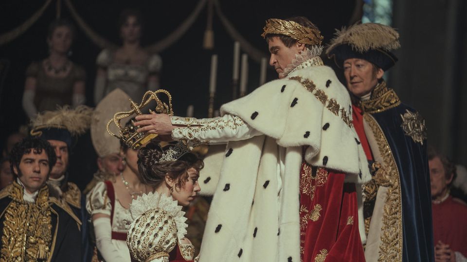 Joaquin Phoenix as Napoleon at the coronation with his wife.