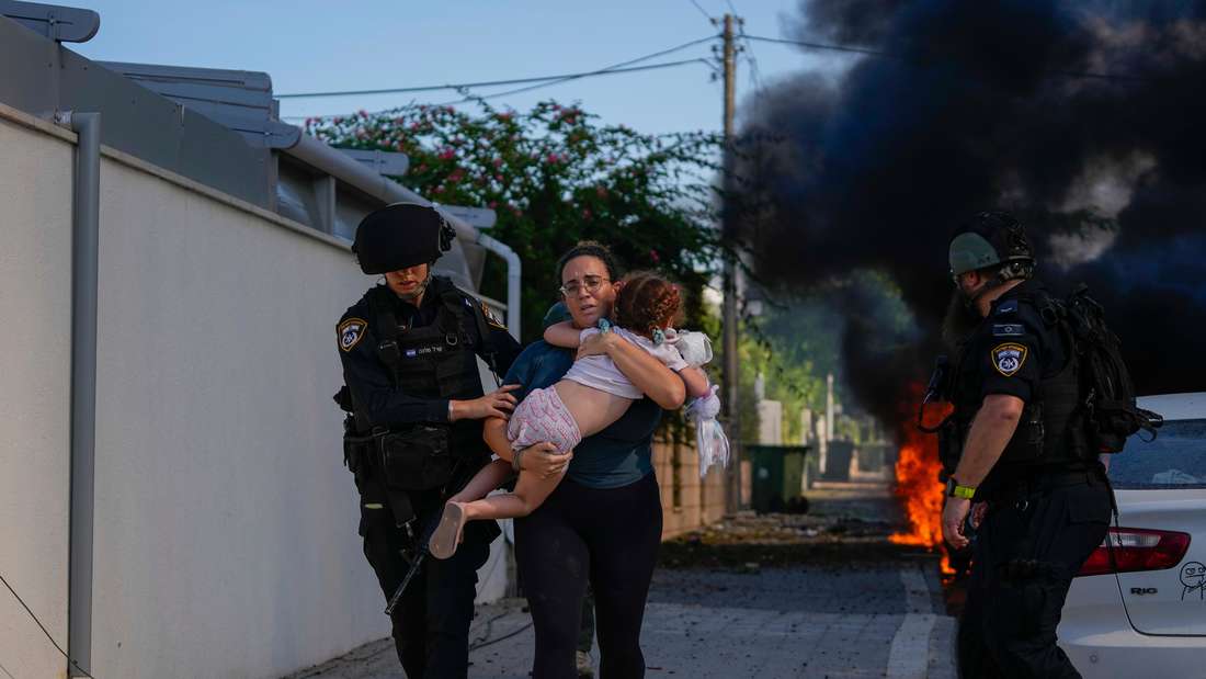 Israeli police officers evacuate woman and child during war in Israel 