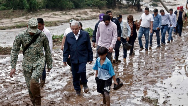 Mexico: Mexican President Andres Manuel Lopez Obrador (third from left) and members of his cabinet had to wade through the mud on the way to the disaster area.