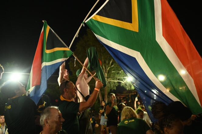 South African supporters celebrate the Springboks' victory on October 28, 2023, in Johannesburg.