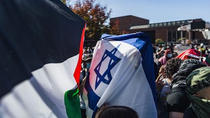 A man draped in an Israeli flag walks through a pro-Palestinian rally in Seattle, Washington state, United States, October 12, 2023. (CHIN HEI LEUNG / MAXPPP)