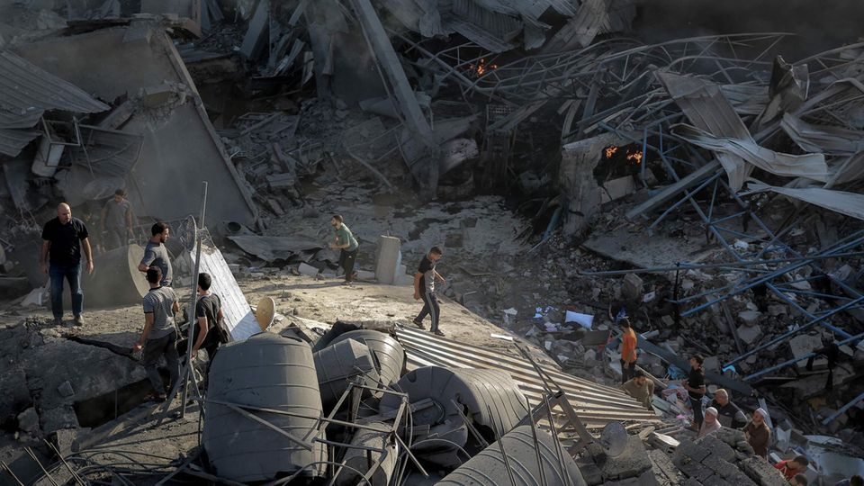 Palestinians search for survivors after an Israeli air force attack on Gaza City