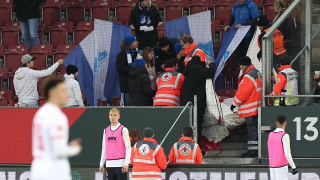 Bundesliga: Shielded from view: After a firecracker explosion, a spectator in the TSG Hoffenheim fan block has to be treated by paramedics.  The game is interrupted for several minutes.