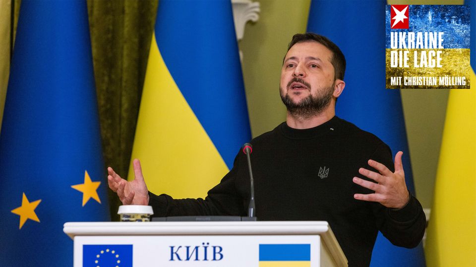 Volodymyr Zelenskyj, President of Ukraine, stands gesticulating at a lectern