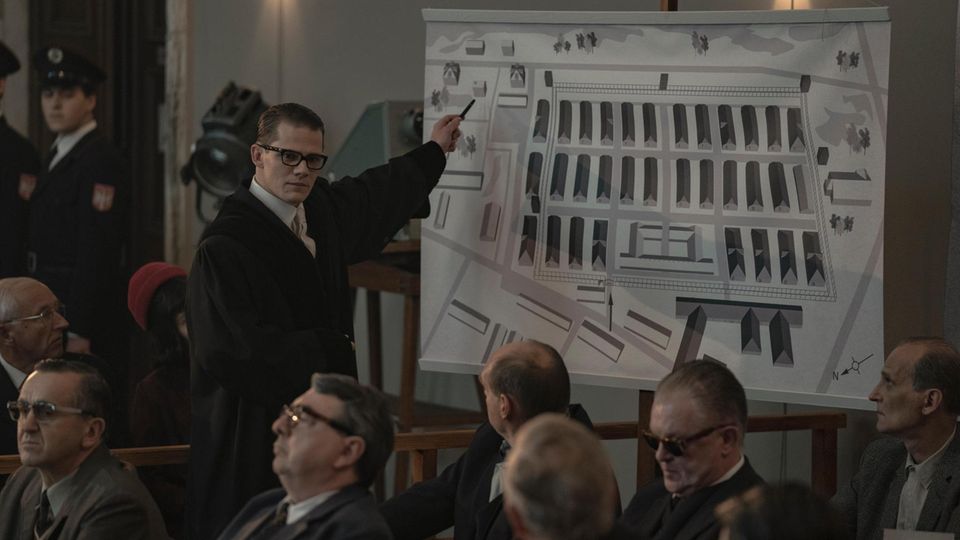 A man points to a building plan