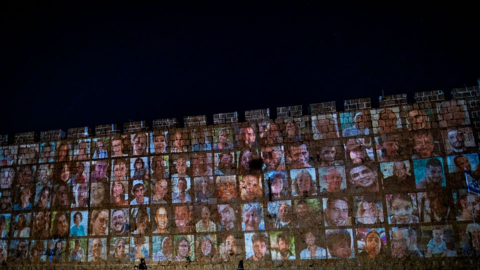 Photos of the people kidnapped from Israel by Hamas are projected onto a wall in the Old City of Jerusalem