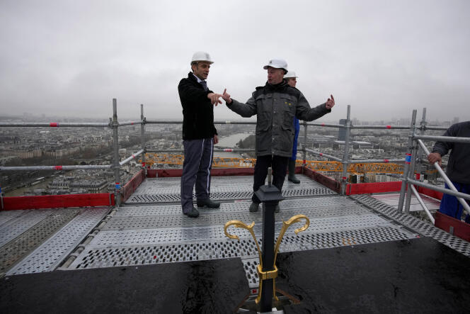 Emmanuel Macron listens to explanations on the renovation site of Notre-Dame de Paris, at the top of the cathedral spire, Friday December 8, 2023.