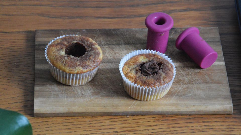 Muffins hollowed out with Cucap on a kitchen board