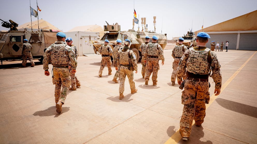 German soldiers in Mali walk to their armored vehicles