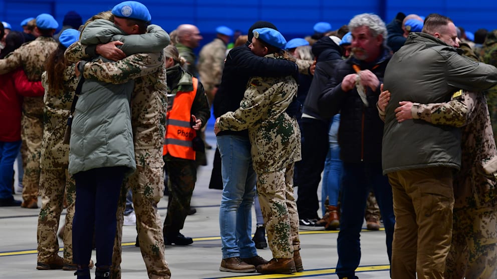 Deep hugs with loved ones in the Air Force hangar