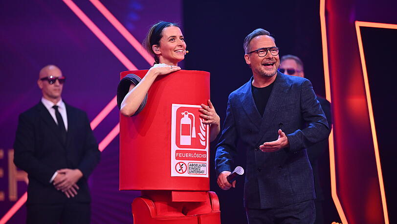 Model Eva Padberg stands as "The fire extinguisher" on the ProSieben show "The Masked Singer" on stage.