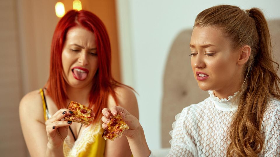 Two women are disgusted by their pizza