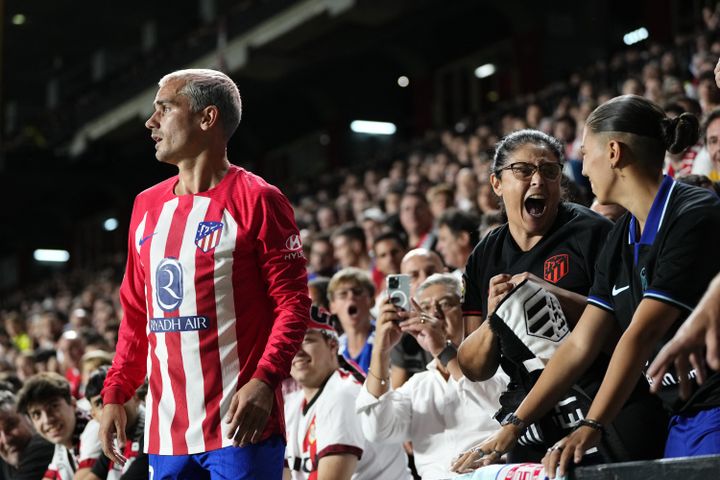 Two Atlético Madrid fans ecstatic as Antoine Griezmann approaches the stands at Vallecas Stadium during a trip to Rayo Vallecano.  (JOSE BRETON / AFP)