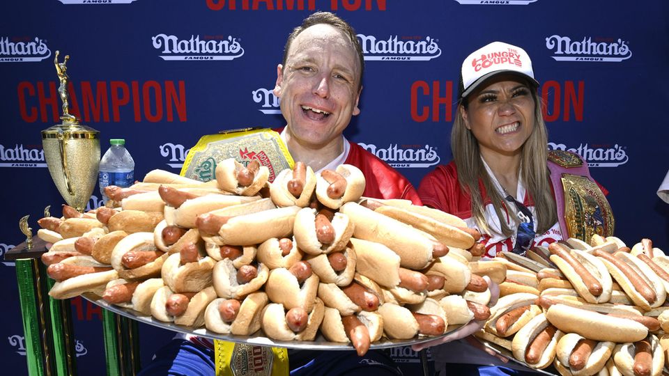 Joey Chestnut with a huge plate full of hot dogs